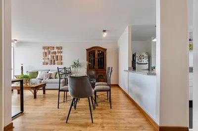 a kitchen and living room with a table and chairs at ALU Apartments - Miraflores Boardwalk, Wifi 70M in Lima