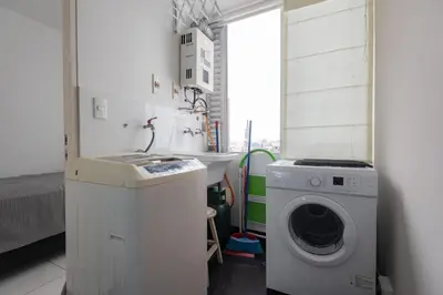 a laundry room with a washing machine and a sink at ALU Apartments - Miraflores Boardwalk, Wifi 70M in Lima