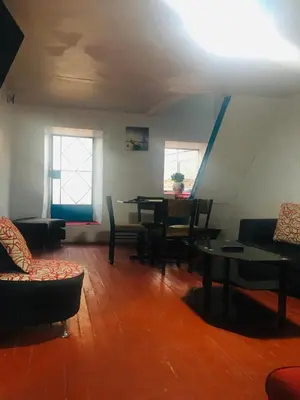 a living room with a table and chairs at Washichay in Cusco