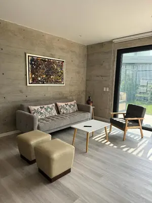 a living room with a couch and a table at 2BR Apartamento Moxie Paracas con Terraza y AC en 1r Piso in Paracas