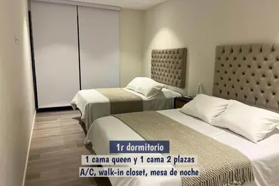 two beds in a hotel room with a sign that says i came queen x i at 2BR Apartamento Moxie Paracas con Terraza y AC en 1r Piso in Paracas