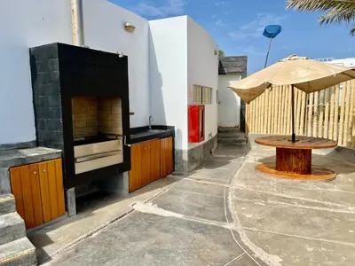 a outdoor patio with a fireplace and a table at 1er Piso Vista a Bahía Paracas - Las Velas 102 T1 in Paracas