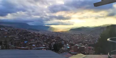a view of a city with a rainbow in the sky at APARTAMENTO VISTA IMPERIAL II Mirador Panoramico in Cusco
