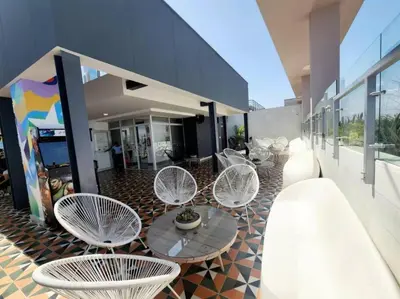 a group of chairs and tables on a building at Audacity Moderno Departamento in Lima