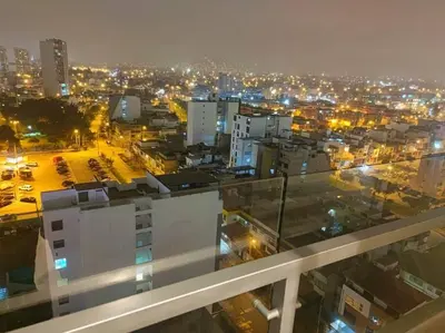 a view of a city at night with lights at Audacity Moderno Departamento in Lima