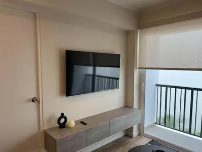 a living room with a flat screen tv on the wall at Mirano by Wynwood House in Lima