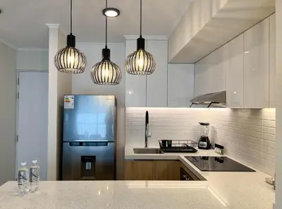 a kitchen with a refrigerator and pendant lights at Mirano by Wynwood House in Lima