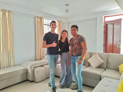 a group of three people standing in a living room at Alemar's House in Nazca