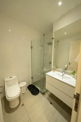 a bathroom with a toilet and a sink and a shower at Departamento de Playa San Bartolo SOL ARENA & MAR in San Bartolo