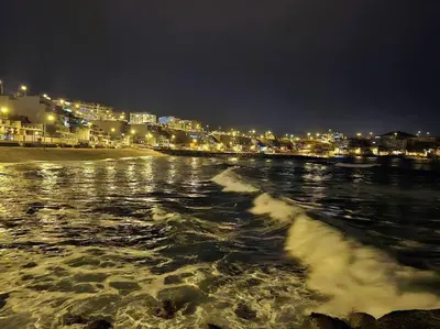 a view of a beach at night with a city at Departamento de Playa San Bartolo SOL ARENA & MAR in San Bartolo