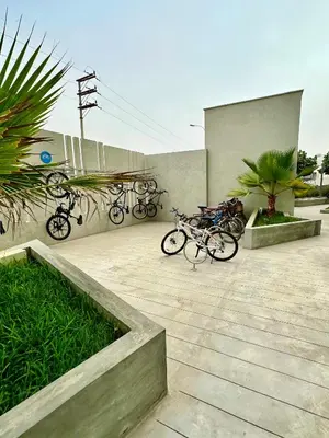 a group of bikes parked next to a building at Depa playa San Bartolo 3 camas piscina wifi juegos in Lima