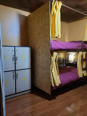 a room with two bunk beds and two refrigerators at Hostal CASA CUSCO in Cusco