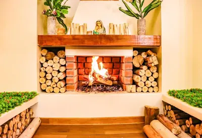 a fireplace in a room with logs at Fundo Alma Andina in Jauja