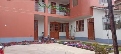 a house with a pile of shoes outside of it at Casa Tejedora in Chinchero