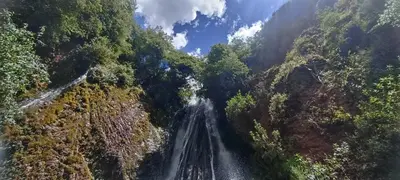 an aerial view of a waterfall in a forest at Casa Tejedora in Chinchero