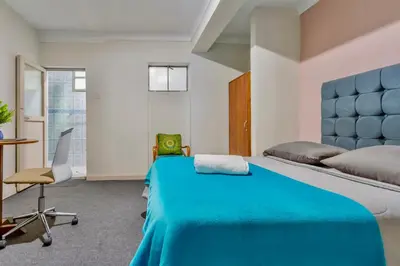 a bedroom with a bed and a desk and a chair at Templo de la Luna in Cusco