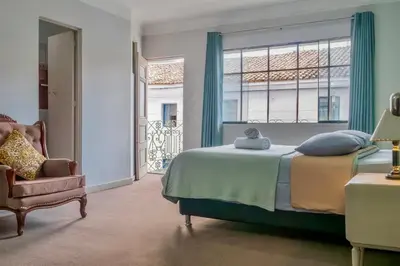 a bedroom with a bed and a chair and a window at Templo de la Luna in Cusco