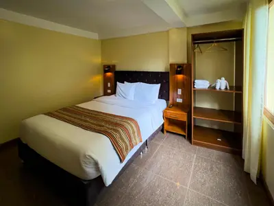 a bedroom with a large white bed in a room at Santuario Machupicchu in Machu Picchu