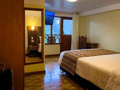 a hotel room with a bed and a mirror at Santuario Machupicchu in Machu Picchu
