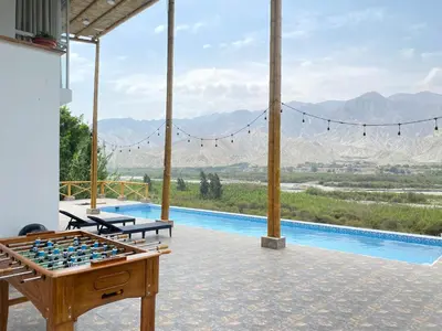 a room with a foosball table and a pool at Mirador del Paraiso in Lunahuaná