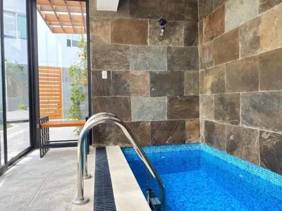 a bathroom with a large tub with a tile wall at Hermoso y céntrico 1BR en Barranco con cochera wifi y netflix in Lima
