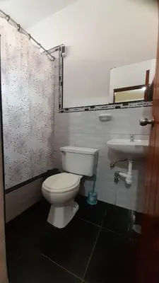 a bathroom with a toilet and a sink at HOSPEDAJE D`NOA En el centro de Oxapampa in Oxapampa