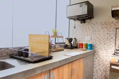 a kitchen with a sink and a counter top at Acogedor Loft equipado con Sofá cama en Matellini in Lima