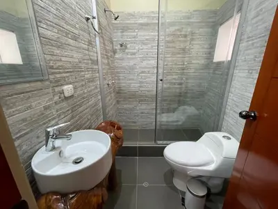 a bathroom with a toilet and a sink and a shower at Anka Wasi Lodging in Cusco