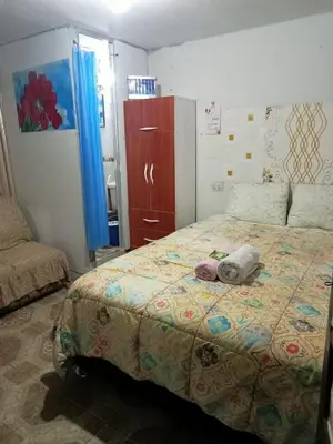 a bedroom with a bed with a stuffed animal on it at POSADA ISABELITA in Lima