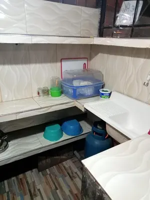 a shelf with bowls and a container on it at POSADA CHABELITA in Lima