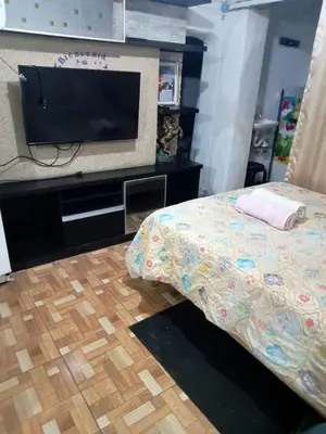 a bedroom with a bed and a flat screen tv at POSADA CHABELITA in Lima