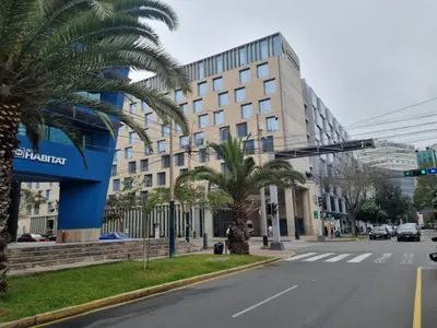 a street with palm trees in front of a building at San Isidro Suites Basadre 1B403 in Lima