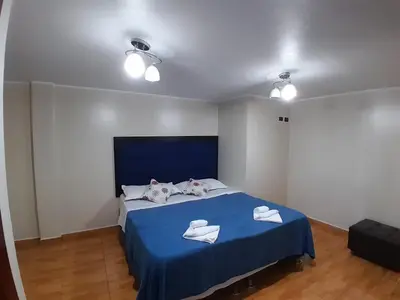 a bedroom with a blue bed with towels on it at HOME BLESSED II in Lima