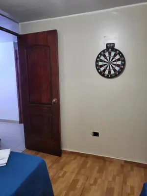 a dart board on a wall next to a door at HOME BLESSED II in Lima