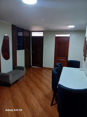 a meeting room with a table and chairs in a room at HOME BLESSED II in Lima