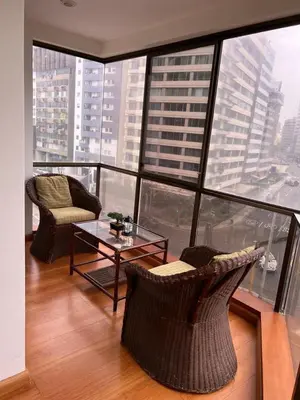 a room with chairs and a table and a large window at APARTAMENTO COMPLETO EN LA MEJOR ZONA DE MIRAFLORES in Lima