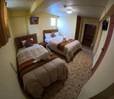 a hotel room with two beds with stuffed animals on them at LA JOYA DE SAN BLAS in Cusco