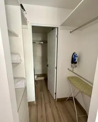 a small bathroom with a toilet and a walk in closet at Departamento amoblado in Lima