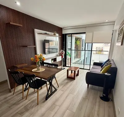a living room with a table and a couch at Departamento amoblado in Lima