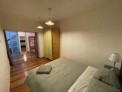 a bedroom with a bed and a hallway with a window at Illa B&B in Cusco
