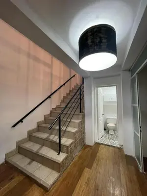 a staircase in a house with a large light at Illa B&B in Cusco