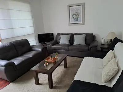 a living room with two couches and a coffee table at Apartamento Temporal en Miraflores in Lima