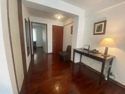 a living room with a desk and a lamp at Apartamento Temporal en Miraflores in Lima