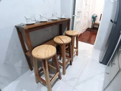 a kitchen with a counter with two stools at APARTAMENTO LINDO - A 2 Cuadras de la Plaza de Armas y del Palacio de Gobierno in Lima
