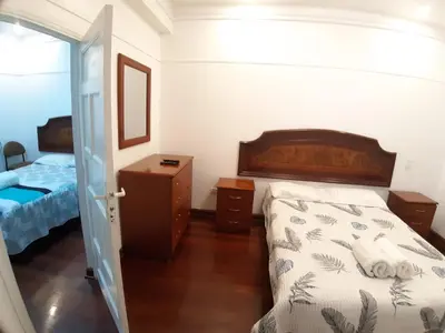 a bedroom with a bed and a bed and a door at APARTAMENTO LINDO - A 2 Cuadras de la Plaza de Armas y del Palacio de Gobierno in Lima