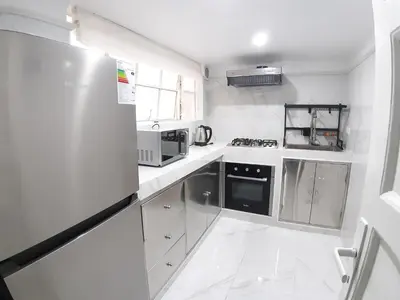 a kitchen with white appliances and a white floor at APARTAMENTO LINDO - A 2 Cuadras de la Plaza de Armas y del Palacio de Gobierno in Lima