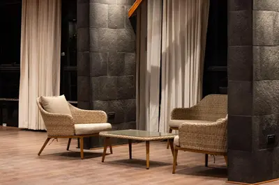 two chairs and a table in front of a window at Hotel California Urubamba in Urubamba