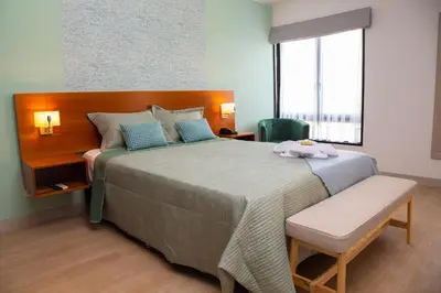 a bedroom with a large bed and a window at Hotel San Blas in Lima