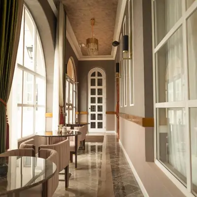 a corridor of a restaurant with tables and windows at Hotel de Turistas Huancayo - Hotel Asociado Casa Andina in Huancayo