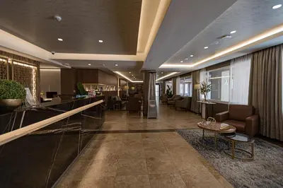 a lobby of a hotel with chairs and a table at Hotel Presidente Huancayo - Asociado Casa Andina in Huancayo